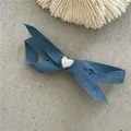 Cute blue denim bow hair clip featuring a polished silver heart center accent detail. - Denim Bow Heart Duckbill Clip (J67-B3) / Medium Blue
