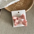 Pair of pink ribbed ribbon bow hair clips on a display card for elegant styling - Ribbon Bow Hair Clip Pair (52-B87) / 2 Pcs/Set / Deep Pink