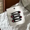 Set of 4 elegant black teardrop hair clips decorated with red beads on a white display card - Teardrop Hair Clip (JX-B166) / Set of 4 / Black (with Dark Red Bead)