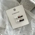 Elegant pair of white heart-shaped pearl duckbill hair clips on white accessories card - Heart Clip Pair (J300-B179) / 2 Pcs/Set / Silver with Artificial Pearl