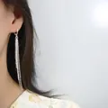 Elegant long silver tassel earrings featuring multiple delicate beaded chains on a model - Starry Tassel Ear Buckle