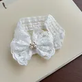Elegant white lace baby headband featuring a decorative bow with a pearl center - White Cotton Headband with Lace Bow and Rhinestones