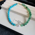 Detailed view of dopamine style necklace with green and blue beads and a central pearl. - Blue-Light Green