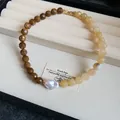 Detail showing color-blocked acrylic faceted beads and baroque pearl on an elegant necklace. - Brown-Light Coffee