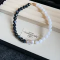 Handcrafted necklace featuring black and white faceted beads and a unique baroque pearl - Black-White