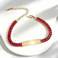 Close-up of gold-plated stainless steel bracelet with red rectangular zircons and engravable bar. - Square Red Rhinestone Style (A635-爪锆-手链) / Gold