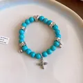 Detail shot of turquoise beaded bracelet with silver cross and heart pendants - 84# Heart and Cross Charm Style / Silver-Turquoise Blue