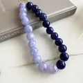 Detailed macro view of a two-tone acrylic beaded necklace in lavender and navy blue tones - Marble Round Bead Necklace / Blue