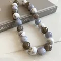 Detailed macro view of marble pattern acrylic beaded necklace in gray and white - Marble Round Bead Necklace / White-Gray
