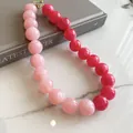 Close-up of vibrant pink and red marble-pattern acrylic beaded necklace on marble - Dopamine Pink Marble Beaded Necklace (82#) / 82# Necklaces - Pink