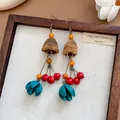 Close-up detail of retro ethnic wooden earrings with colorful beads and teal petals. - Retro Ethnic Long Style (20#)