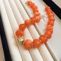Close-up of vibrant orange beads and gold accents on a stylish summer necklace chain - Gold-Orange (76#)