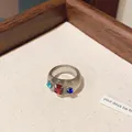 Macro view of a chunky grey translucent resin ring featuring vibrant multi-color gemstones - Style 4: Ring / Gray And Red