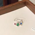 Close-up of a chunky transparent resin ring featuring vibrant multi-color rhinestones - Style 1 Ring / White-Green