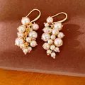 Elegante goudkleurige cluster pareloorbellen met parels in diverse maten - Oorbelhaakjes / Goud-Bruin