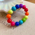 Close-up of vibrant dopamine style colorful acrylic beaded bracelet on shell dish - Style 83 (Multicolor)