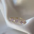 Adjustable 18K gold plated ring with purple zircon flower patterns on white silk fabric - Adjustable Open / Purple Flower Baguette Zirconia (JZ006)