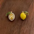 Detailed view of 14k gold plated lemon earrings with yellow crystal and green enamel - Lemon Stud Earrings (HE34782) / Yellow