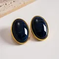 Elegant vintage oval acrylic stud earrings with navy blue marble pattern and gold finish - Blue