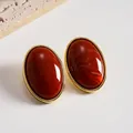Vintage marbled reddish-brown acrylic oval stud earrings with gold-toned frame - Orange