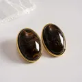 Vintage oval stud earrings featuring brown marble acrylic patterns and gold-tone frames - Brown