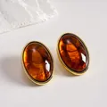 Vintage amber acrylic oval stud earrings featuring a luxurious gold-toned metal frame - Dark Coffee
