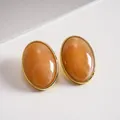 Elegant vintage oval marbled orange acrylic stud earrings with gold-tone frame and silver pins. - Light Coffee