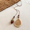 Detailed macro shot of vintage Maillard wooden acorn and woven drop pendant necklace - Straw Woven Acorn Vintage Style (50#)