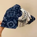 Detailed close-up of a bohemian hair claw clip featuring a blue paisley fabric bow and ornate silver tassels. - Claw Clip Style / Silver-Blue