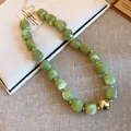 Close-up detail of green marble acrylic beads and golden sphere on Bohemian style necklace - Green Marble and Gold Decorative Ball Necklace (85#) / Necklace #85 - Gold, Green