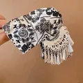 Macro view of vintage black and white paisley fabric and silver metal tassel hair claw - Tassel Printed Hair Claw / Silver