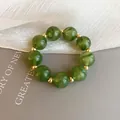 High-quality close-up of a green resin bead bracelet with elegant gold spacer beads - Style 82 (Green)