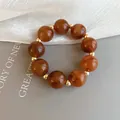 Elegant marbled amber resin bead bracelet with gold spacers shown in detailed close-up. - Style 81 (Brown)
