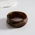 Detailed shot of a vintage marbled resin bangle with geometric brown and gold tones. - Style 8 (Thick Square Coffee)