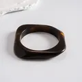 Detailed view of a retro dark amber resin bangle with a geometric square design - Style 9 (Rounded Square Coffee)