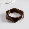 Close-up view of a vintage tortoiseshell resin geometric bangle with faceted edges - Style 5 (Polyhedron Coffee)