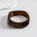 Detailed view of the dark brown swirled resin texture on a geometric square bangle - Style 7 (Asymmetric Square Coffee)