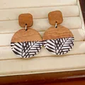 Detailed view of vintage resin and wood round earrings with black leaf pattern - Tree Branch