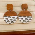 Detailed view of handmade wood and white resin circular earrings with grey fan pattern print - Grass