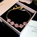 Close-up of elegant 18k gold plated bracelet featuring five sparkling pink zircons in gift box. - 1# Bracelet / Gold-Pink