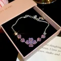 Detailed macro shot of silver bracelet with purple heart-shaped zircons in pink jewelry box - Style 3 Bracelet / Silver-Pink