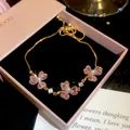 Detailed view of gold-plated bracelet with pink heart crystals and pearls in gift box. - 4# Bracelet / Gold-Pink