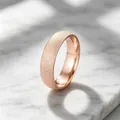 Close-up detail of a minimalist frosted rose gold titanium steel ring on marble surface - Size 5 / 6mm / Rose Gold