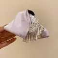 Detail view of lavender embroidered fabric and silver ethnic fringe on a hair claw clip. - Ethnic Style Embroidery Tassel Hair Claw / Silver-Pink