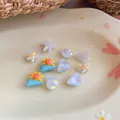 Selection of colorful resin DIY charms with starfish and sun shapes on a decorative plate. - Star Flower DIY Accessories / 10 Pieces Pack / White, Blue, Yellow