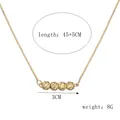 Gedetailleerd overzicht van vergulde boxketting met vier getextureerde kralen en afmetingen - Ketting / 45+5cm
