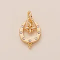 Close-up of golden horseshoe shoe charm with crystals and star center accessory - Horseshoe Pendant