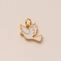 Close-up macro detail of a white enamel dove bird charm pendant with gold copper finish - Pigeon Pendant / White