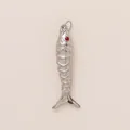 Macro view of a silver stainless steel fish pendant with a distinctive red eye detail - No.7 Red-Eyed Fish / Silver