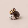 Handcrafted ceramic hedgehog charm with 18K gold-plated ring on beige background - 8 Hedgehog Pendant